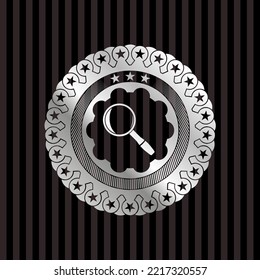 magnifying glass icon inside silver badge or emblem. 