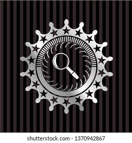 magnifying glass icon inside silvery shiny emblem
