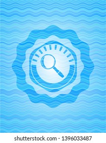 magnifying glass icon inside water wave representation style emblem.