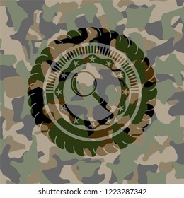 magnifying glass icon on camo pattern
