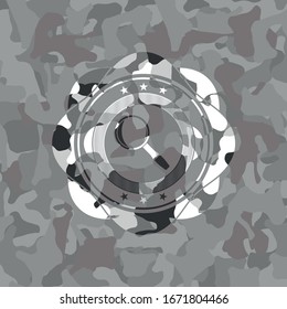 magnifying glass icon on grey camouflaged texture