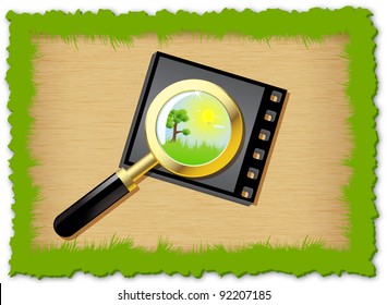 A magnifying glass is located on a photographic negative with herbal frame