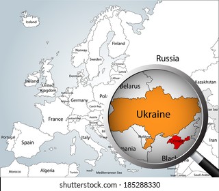 Magnifying glass over map of Europe, part of Asia and Africa, focusing Ukraine and Crimea peninsula