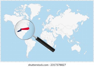 Magnifying glass showing a map of North Carolina on a world map. North Carolina flag and map enlarge in lens. Vector Illustration.