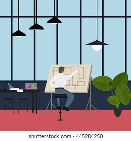 main architect working at drawing desk in office