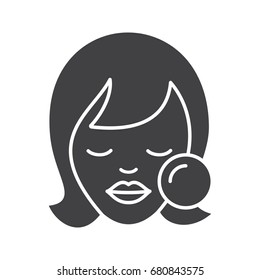 Makeup glyph icon. Woman face with makeup sponge. Blush application. Beauty salon. Silhouette symbol. Cosmetic removing. Negative space. Vector isolated illustration