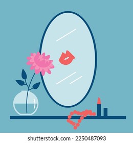 Makeup table with accessories, flower vase and mirror with a lipstick kiss mark on it