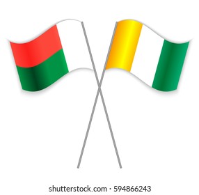 Malagasy and Ivorian crossed flags. Madagascar combined with Ivory Coast isolated on white. Language learning, international business or travel concept.