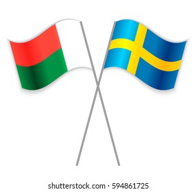 Malagasy and Swedish crossed flags. Madagascar combined with Sweden isolated on white. Language learning, international business or travel concept.