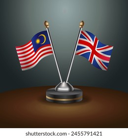 Malasia y Reino Unido banderas de mesa relación con el fondo de gradiente