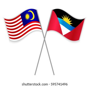 Malaysian and Antiguan crossed flags. Malaysia combined with Antigua and Barbuda isolated on white. Language learning, international business or travel concept.