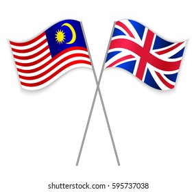 Malaysian and British crossed flags. Malaysia combined with United Kingdom isolated on white. Language learning, international business or travel concept.