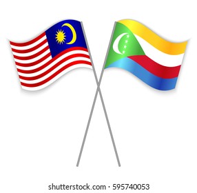 Malaysian and Comoran crossed flags. Malaysia combined with Comoros isolated on white. Language learning, international business or travel concept.