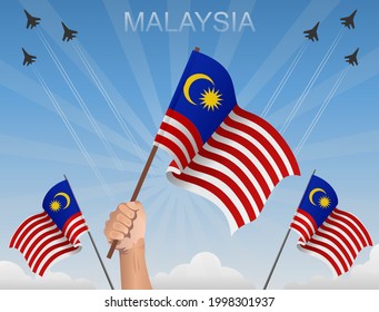 Malaysian flags fluttering under the blue sky