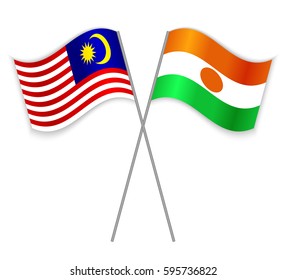 Malaysian and Nigerien crossed flags. Malaysia combined with Niger isolated on white. Language learning, international business or travel concept.