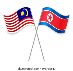Malaysian and North Korean crossed flags. Malaysia combined with North Korea isolated on white. Language learning, international business or travel concept.