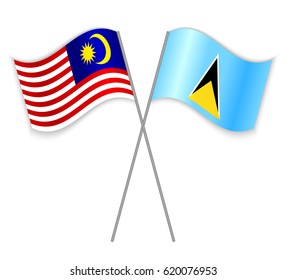 Malaysian and Saint Lucian crossed flags. Malaysia combined with Saint Lucia isolated on white. Language learning, international business or travel concept.