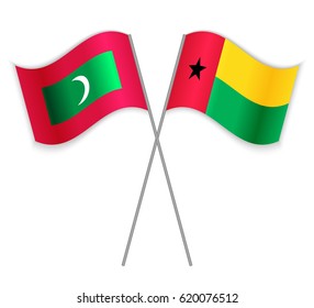 Maldivian and Bissau-Guinean crossed flags. Maldives combined with Guinea-Bissau isolated on white. Language learning, international business or travel concept.