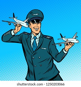 male airplane pilot. Model aircraft in hand. Pop art retro vector illustration kitsch vintage