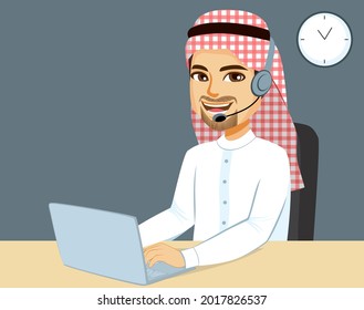 Male Arab Muslim worker on call center office working with laptop and headset