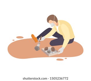 Male Archaeologist Sitting on Ground and Sweeping Dirt from Stones Using Brush, Paleontology Scientist Character Working on Excavations with Historical Artifacts Flat Vector Illustration