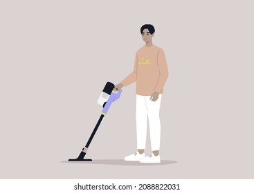 A male Asian character cleaning with a cordless vacuum cleaner, household chores