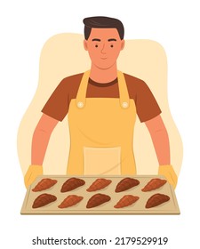 Male Baker Holding Tray of Croissants.