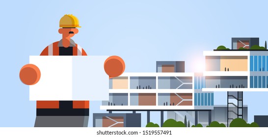 male builder architect holding blueprint workman engineer with empty placard board industrial worker in uniform building concept modern office exterior flat portrait horizontal