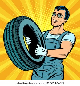 Male Car Mechanic With Wheel. Pop Art Retro Vector Illustration Comic Cartoon Kitsch Drawing