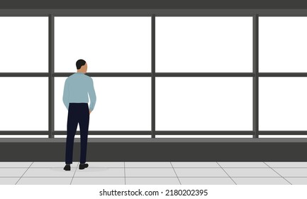 A male character in business clothes stands and looks out the big window