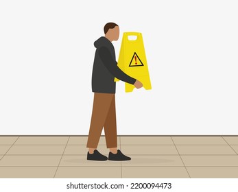 A male character with a floor warning sign in his hands stands indoors