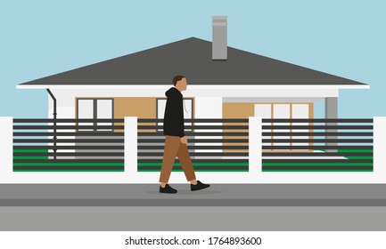 
A male character goes along the sidewalk past a one-story house