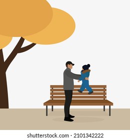 A male character with a small child in his arms stands near a bench in autumn