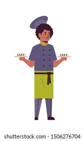 male chef cook holding trays with fresh sushi rolls african american man restaurant kitchen worker in uniform carrying platter with japanese traditional food cooking concept full length vertical