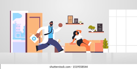 male doctor with first aid kit running to help woman patient medicine healthcare ambulance concept african american medical worker in white coat living room interior full length flat horizontal
