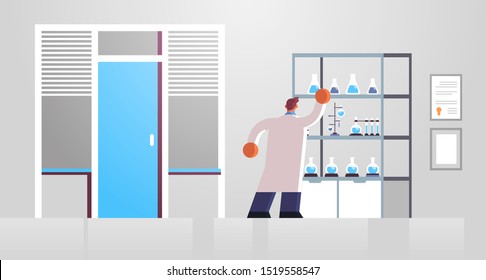 male doctor laboratory scientist in white coat working with test tubes medicine healthcare concept hospital medical clinic lab interior full length rear view flat horizontal