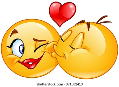 Male emoticon kissing a female emoticon.