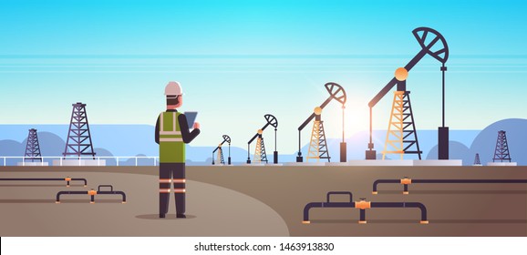 Male Engineer Refinery Worker Using Tablet Oil Pump Rig Energy Industrial Zone Oil Drilling Fossil Fuels Production Concept Flat Mountains Sunset Background Horizontal Full Length