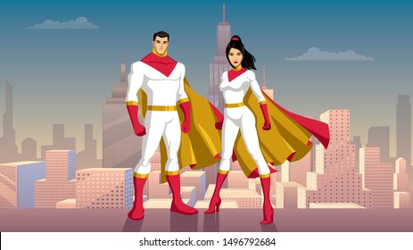 Male And Female Asian Superheroes Posing In Front Of Beautiful Cityscape.