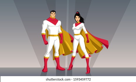 Male and female Asian superheroes posing in front of light.