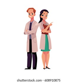 Male and female doctors in white medical coats, man with arms folded, woman pointing right, cartoon vector illustration isolated on white background. Full length portrait of two doctors, front view