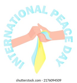 Male and female hands hold each other in a circle from the inscription International Day of Peace with the Ukrainian flag