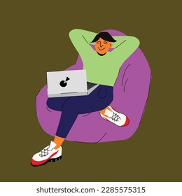 A male freelancer is relaxed and resting with a laptop on his lap. A happy employee chilling in a bean bag chair, free from stress, good online work.