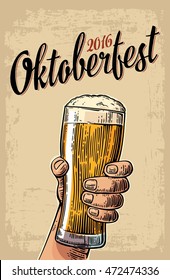 Male hand holding a beer glass. Vintage vector engraving illustration for web, poster, invitation to party time to drink. Isolated on beige background