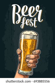 Male hand holding a beer glass. Beer fest lettering. Vintage color vector engraving illustration for web, poster, invitation to party or festival. Isolated on dark background