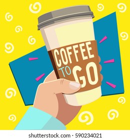 Male hand holding disposable cup for coffee with text "Coffee to go"