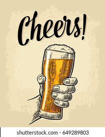 Male Hand Holding A Full Beer Glass With Foam. Cheers Toast Lettering. Vintage Vector Color Engraving Illustration For Web, Poster, Greeting Card, Invitation To Party. Isolated On Beige Background