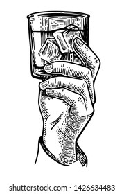 Male hand holding a glass of alcohol