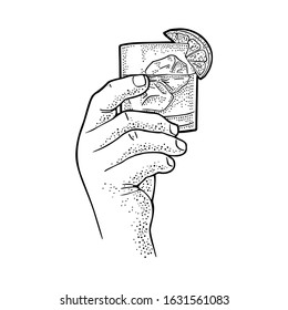 Male hand holding glass gin. Vintage black vector engraving illustration for label, poster, invitation to party. Isolated on white background