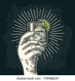 Male hand holding a glass with gin, lime and ice cubes. Vintage vector color and monochrome engraving illustration for label, poster, invitation to party. Isolated on dark background